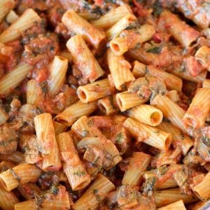 Pasta with mushrooms, red sauce and spinach.