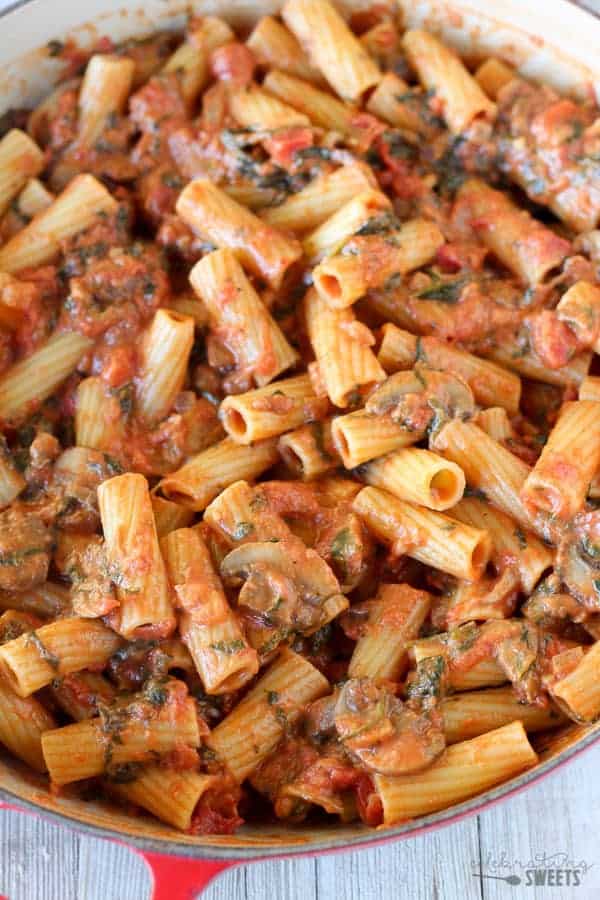 Pasta with mushrooms, red sauce and spinach.