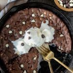 Chocolate skillet cookie topped with ice cream.