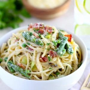 Bowl of pasta with asparagus and bacon.