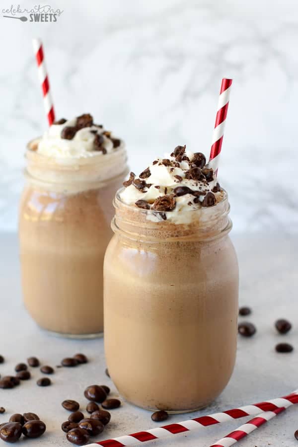 Coffee frappe in a mason jar topped with whipped cream.