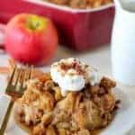 Plate of apple french toast casserole topped with whipped cream.