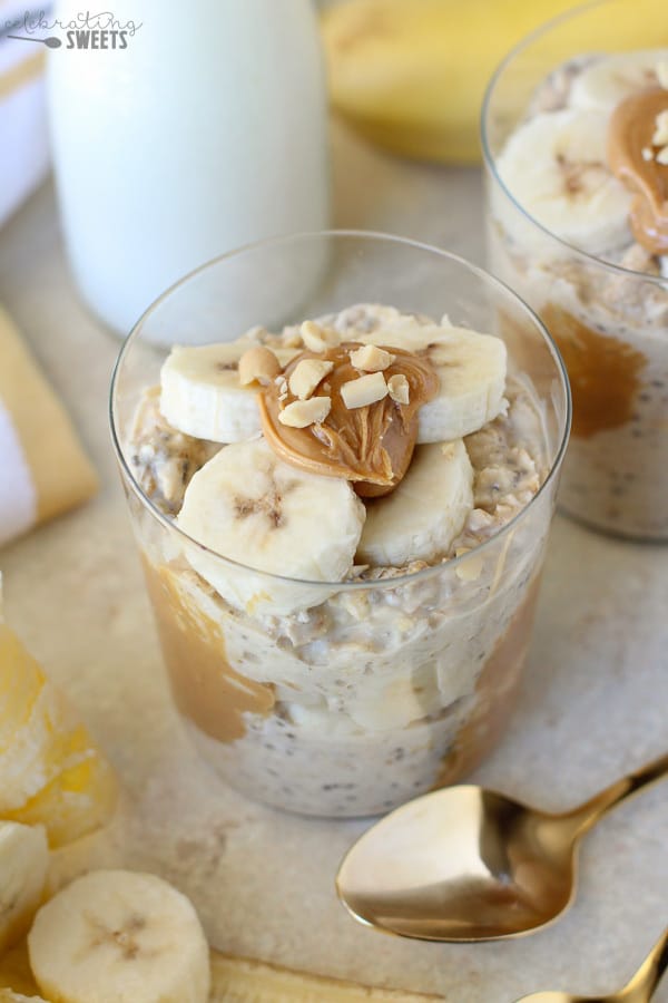 Overnight oats with peanut butter and sliced banana in a glass.
