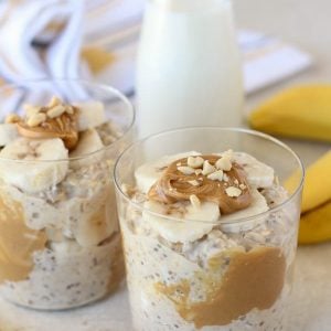 Overnight oats with peanut butter and sliced banana in a glass.