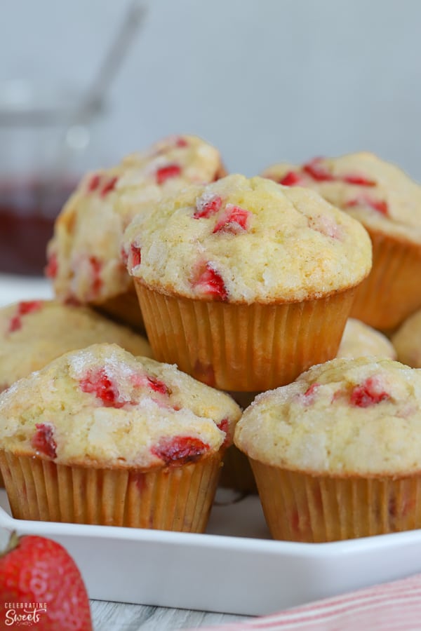 White plate with a pile of strawberry muffins.