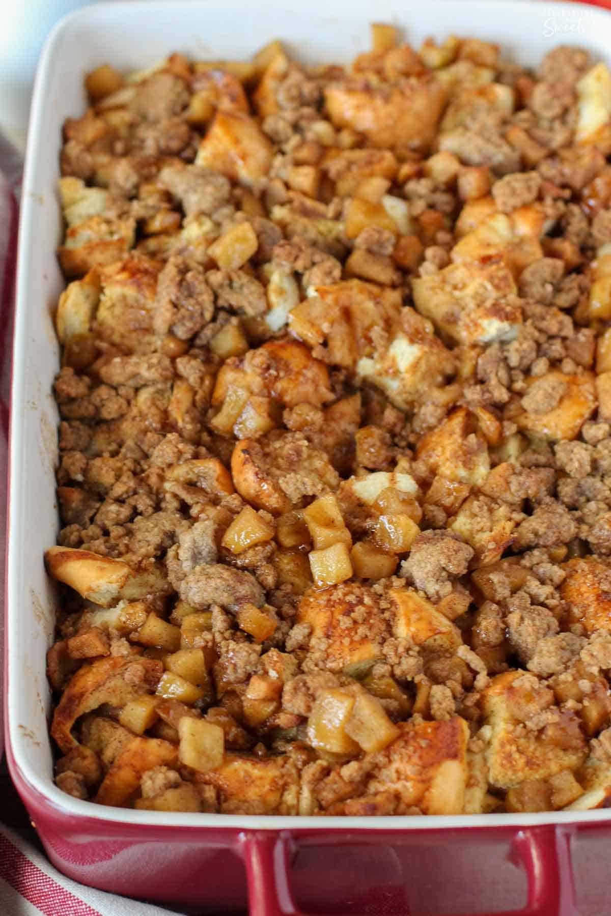 Apple French Toast casserole in a red baking dish.