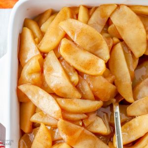 Cinnamon Apples in a white baking dish.