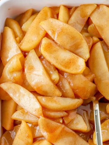 Cinnamon Apples in a white baking dish.