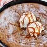Skillet cookie topped with ice cream and caramel.