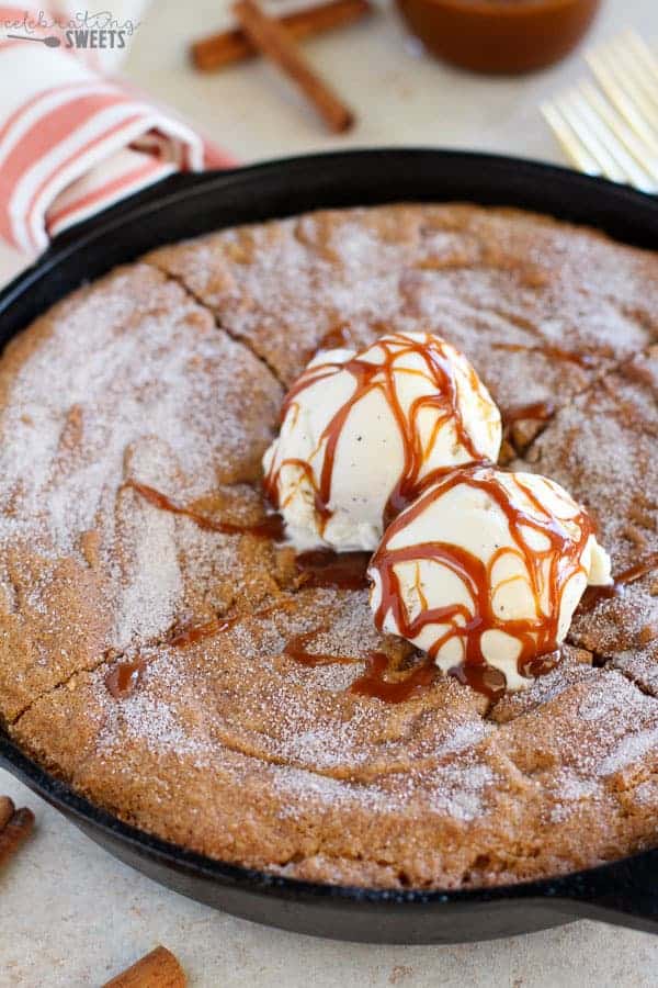 Skillet cookie topped with ice cream and caramel.