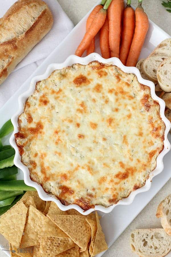 Artichoke dip in a white casserole dish