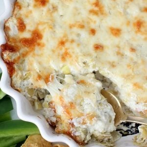 Artichoke dip in a white casserole dish