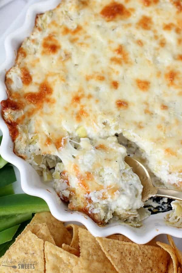 Artichoke dip in a white casserole dish