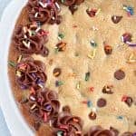 Chocolate Chip Cookie Pie topped with chocolate frosting and sprinkles.