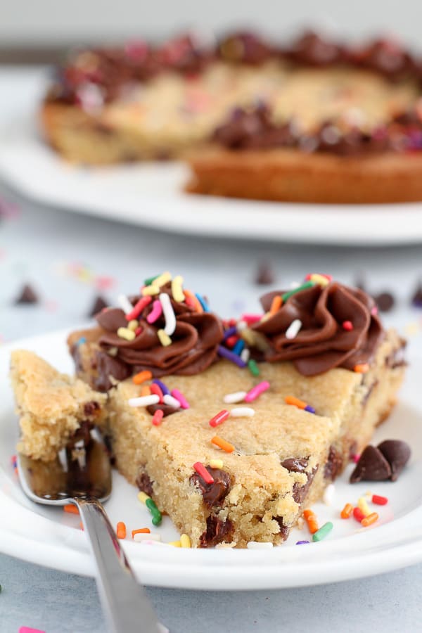 Slice of chocolate chip pie on a white plate with a fork.