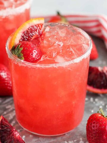 Strawberry Margarita in a glass with crushed ice.