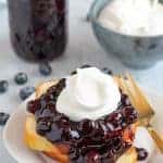 Blueberry Sauce on a Stack of Pound Cake with Whipped Cream.