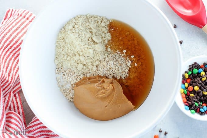 white bowl with oats, peanut butter, and honey.