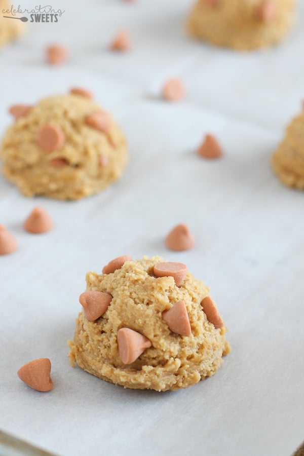 Scoops of peanut butter cookie dough on a baking sheet.