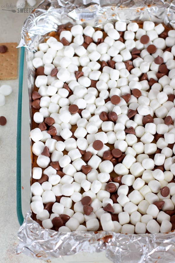 Mini marshmallows and chocolate chips on top of cookie bars.