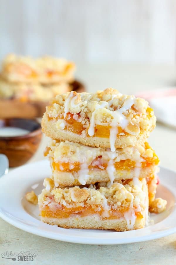 Stack of Peach Crumb Bars on a white plate.