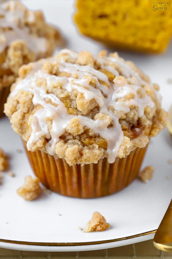 Close up of pumpkin muffin with crumb topping and drizzle of icing.