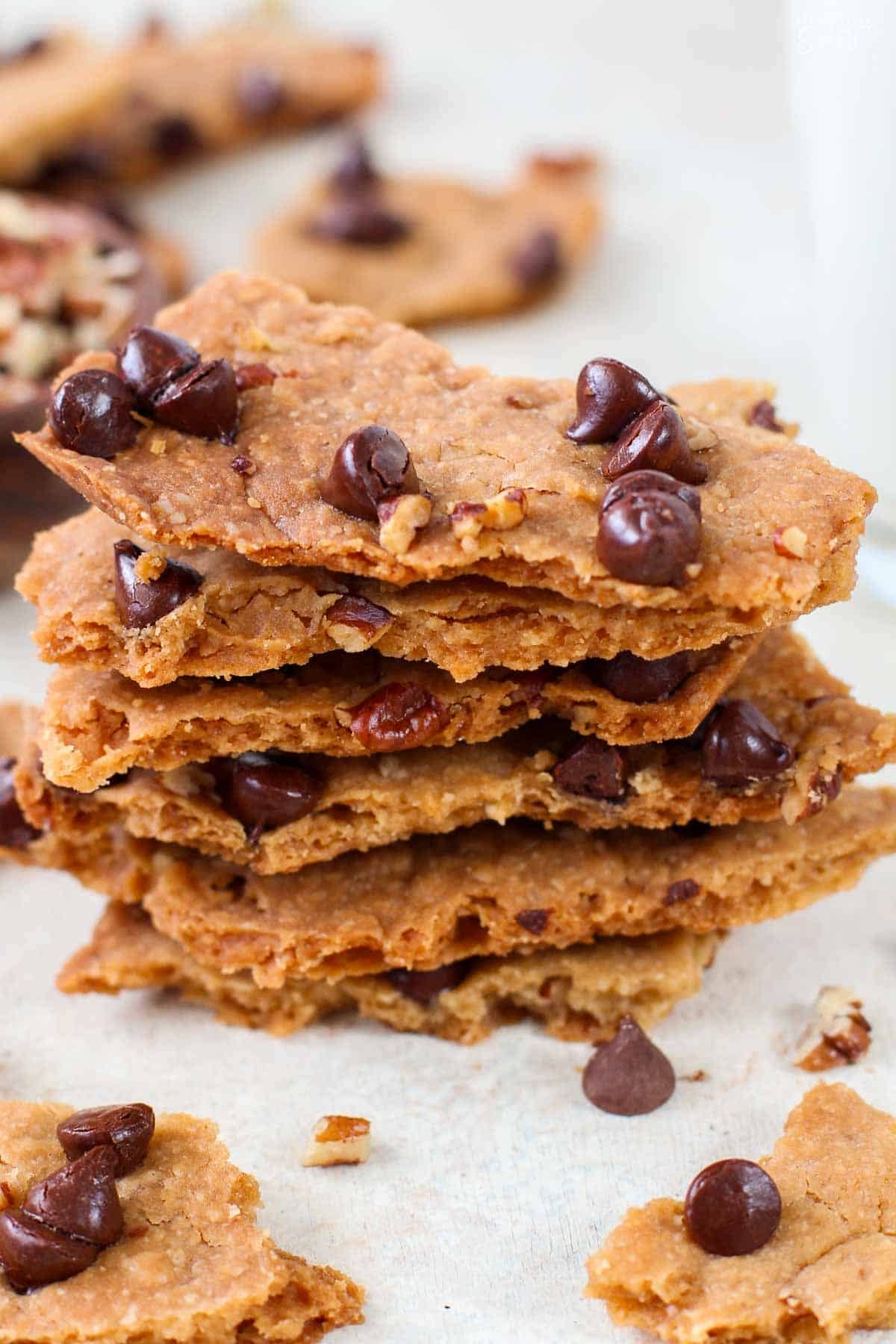 A stack of chocolate chip cookie brittle topped with chocolate chips.
