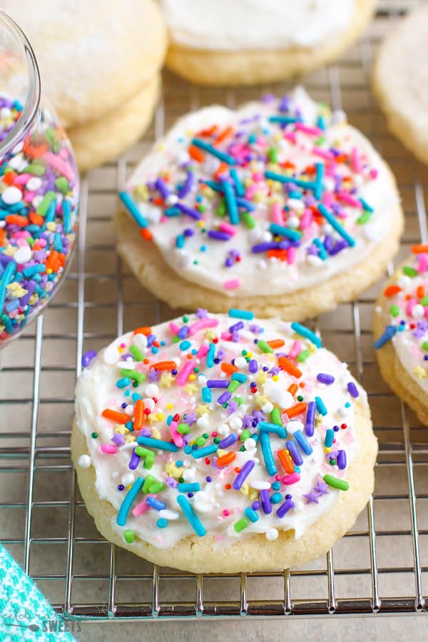 Sugar cookies topped with frosting and sprinkles. 