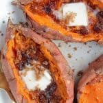 Baked Sweet Potatoes topped with butter and brown sugar.