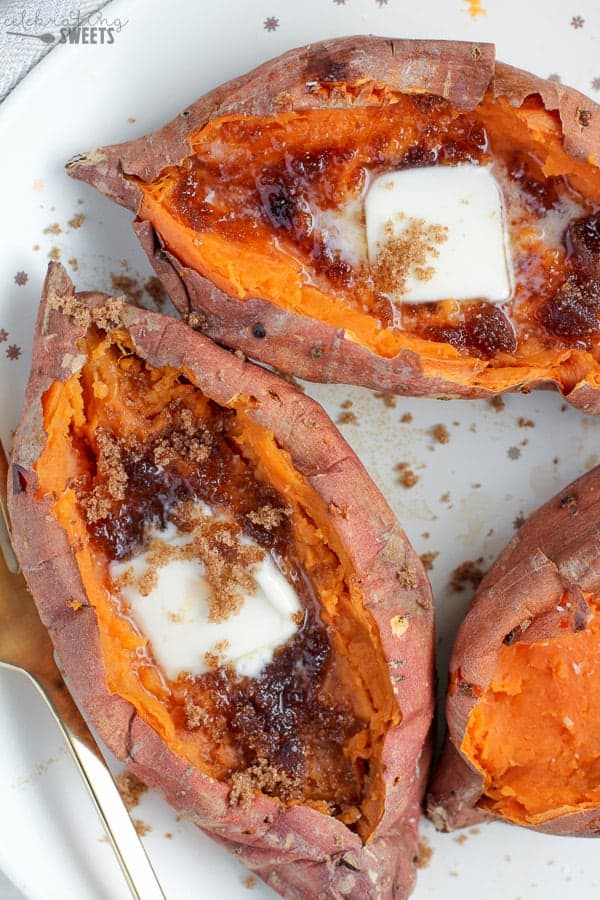 Baked Sweet Potatoes topped with butter and brown sugar.