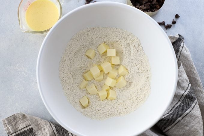 Step by step scones: Butter cubes in a bowl of flour.