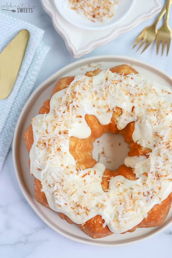 Coconut Bundt Cake topped with cream cheese frosting and toasted coconut.