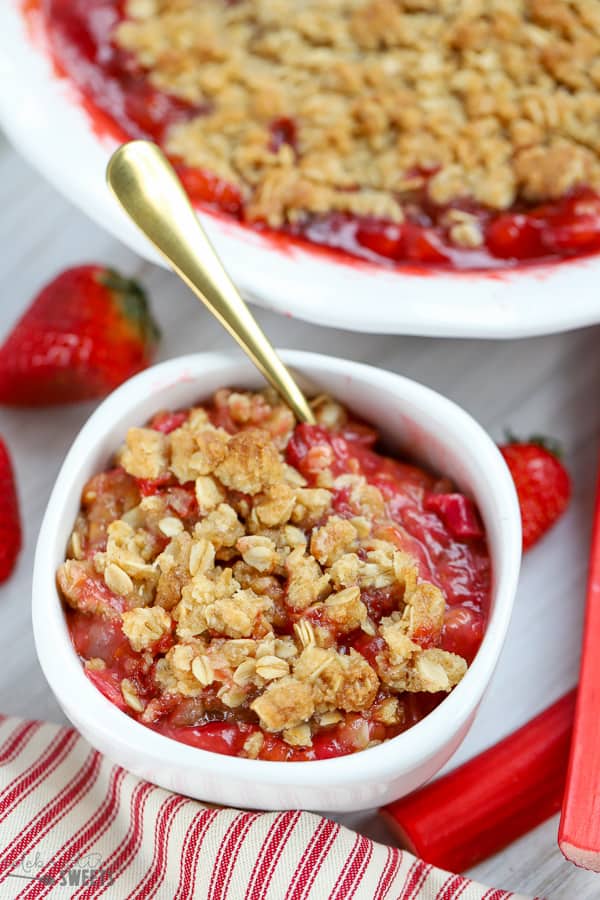 White bowl filled with strawberry rhubarb crisp.