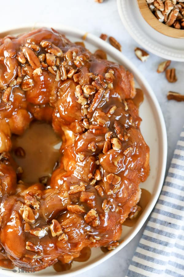 Overhead shot of money bread topped with pecans. 