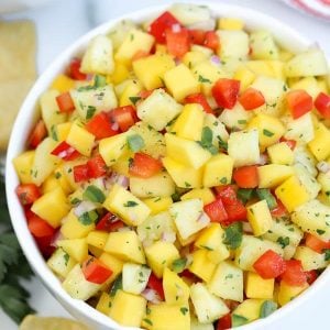 Pineapple mango salsa in a large white bowl.