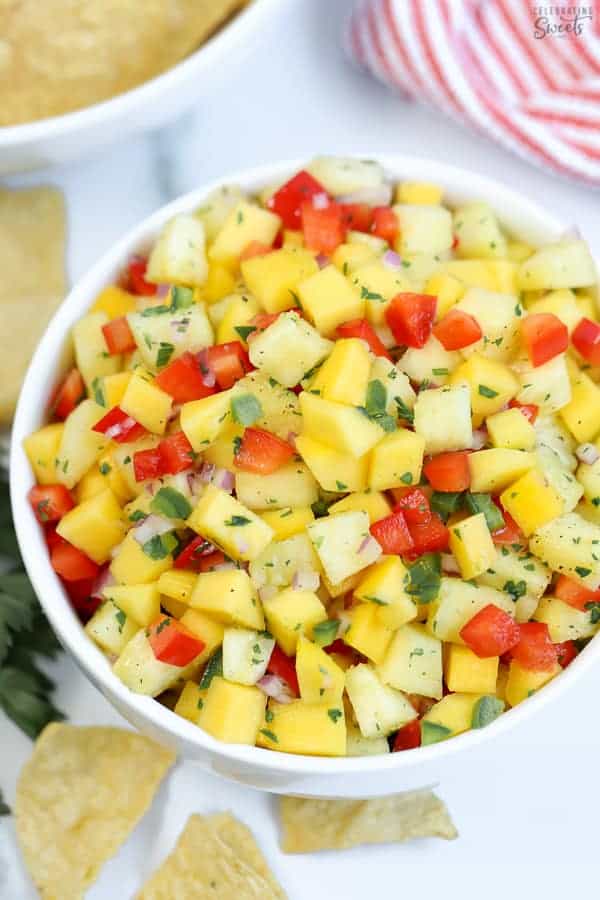 Pineapple mango salsa in a large white bowl.
