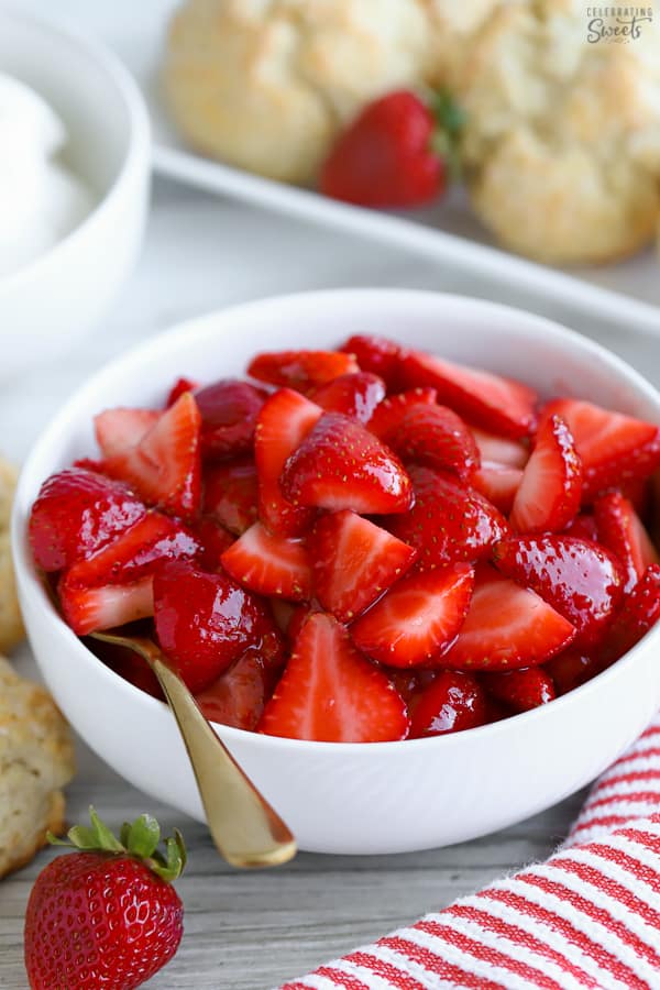Bowl of sliced strawberries in a white bowl.