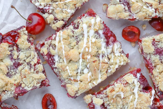 Almond Cherry Streusel Bars on parchment paper,