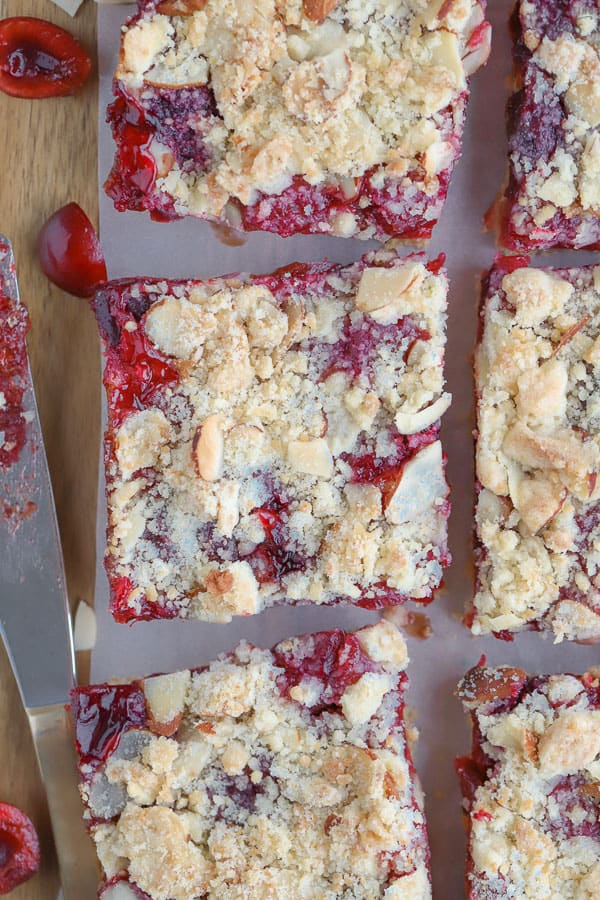 Almond Cherry Streusel Bars on parchment paper,