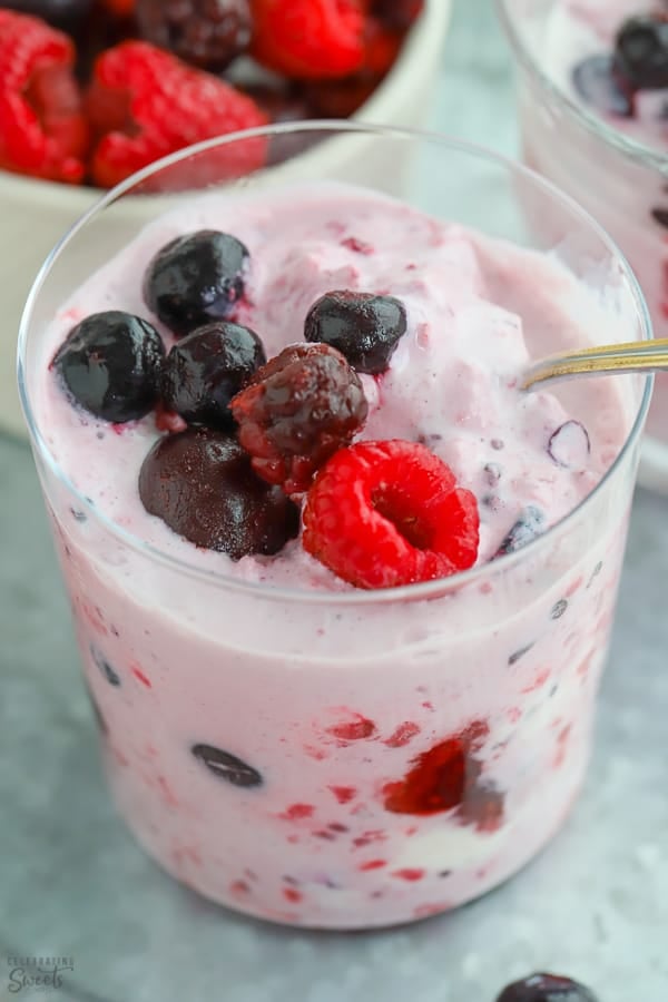 Berries mashed with vanilla ice cream in a glass.