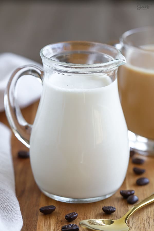 Vanilla coffee creamer in a small glass pitcher.