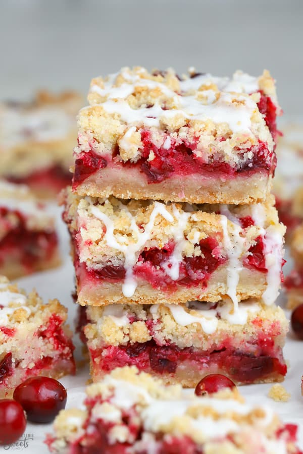 Stack of three Cranberry Bars drizzled with vanilla icing.