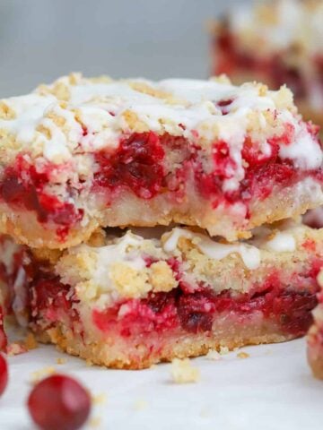 Two Cranberry Bars on parchment paper.