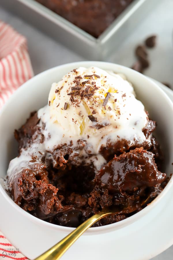 Chocolate Pudding Cake in a white bowl topped with a scoop of vanilla ice cream.
