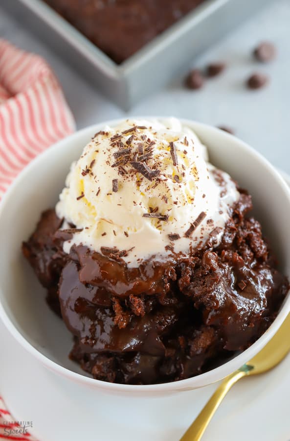 Chocolate Pudding Cake in a white bowl topped with a scoop of vanilla ice cream.