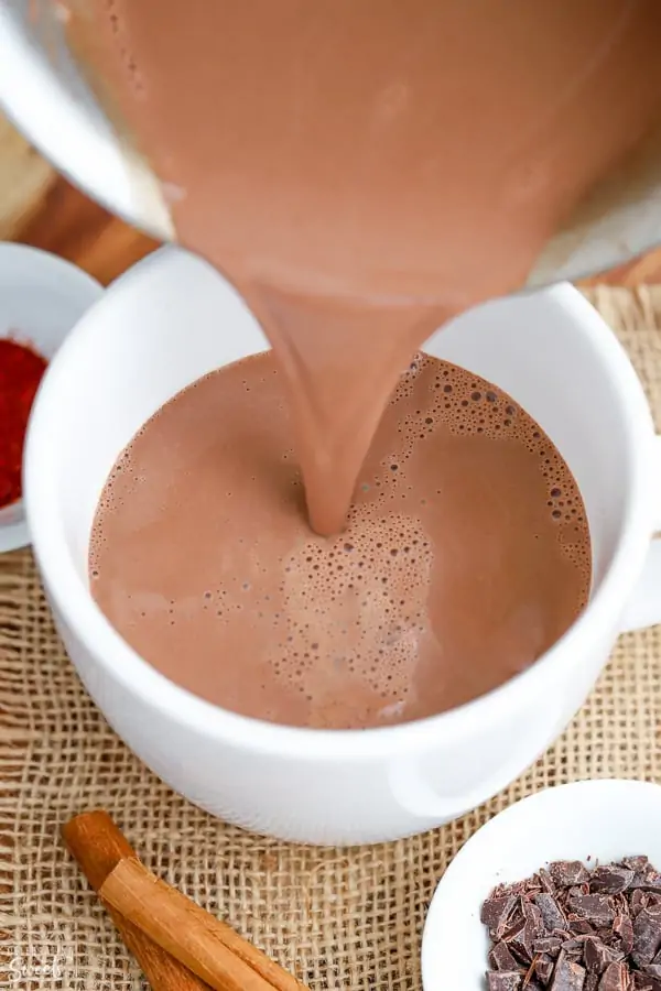 Hot Chocolate being poured into a white mug.