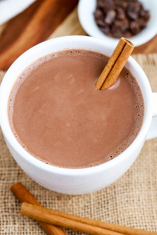 Mexican Hot Chocolate in a white mug garnished with a cinnamon stick.