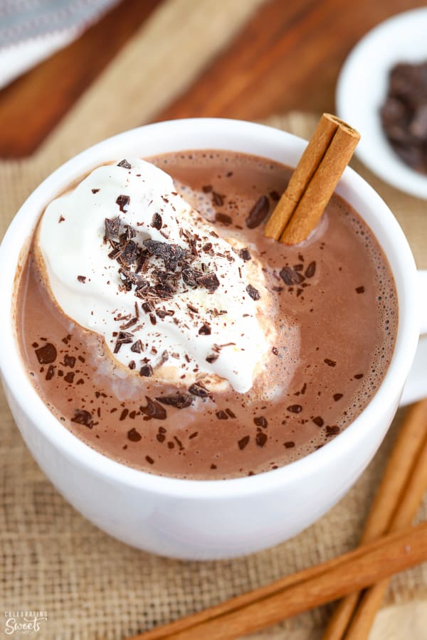 Mexican Hot Chocolate in a white mug topped with whipped cream and chocolate.