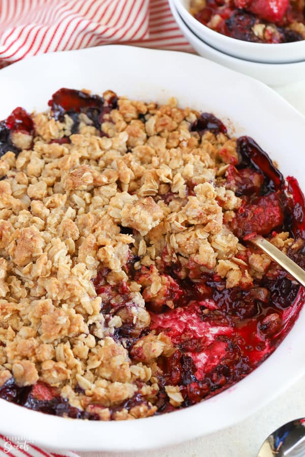 Berry crisp in a white baking dish.
