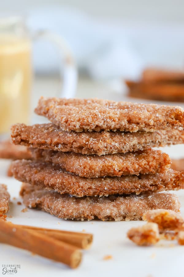 Stack of cinnamon cookies on parchment paper.